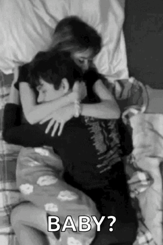 Man and Woman Hugging in Bed
