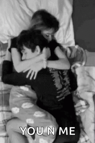 Man and Woman Hugging in Bed