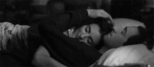 Man and Woman Hugging in Bed