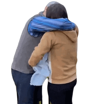 Man And Woman Hugging In Blue Jackets