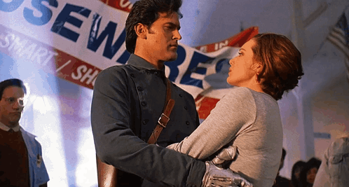 Man and Woman Hugging in Front of Sewer Banner
