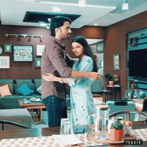 Man and Woman Hugging in Living Room Tanuja