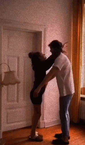 Man and Woman Hugging in Room
