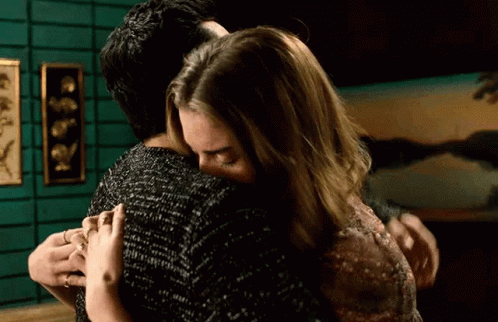 Man and Woman Hugging in Room