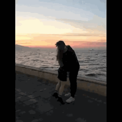 Man and Woman Hugging Near Ocean