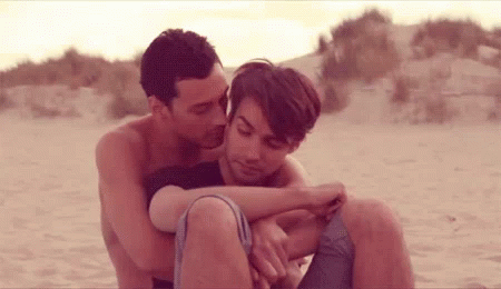 Man and Woman Hugging on Beach