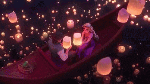 Man And Woman In Boat Looking At Floating Lanterns GIF