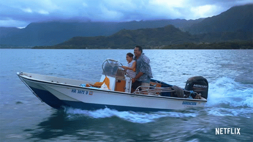 Man And Woman In Boat With Mercury Motor GIF