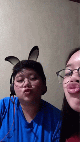 Man and Woman in Bunny Ears and Glasses Making a Face