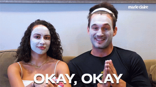 Man And Woman In Face Masks Saying Okay Okay GIF
