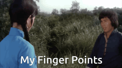 Man And Woman In Field Saying My Finger Points GIF