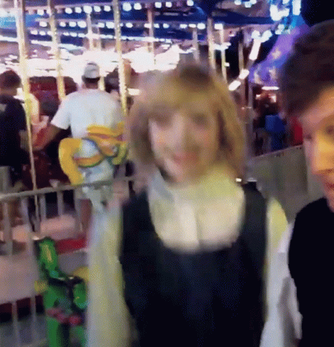 Man and Woman in Front of Ferris Wheel