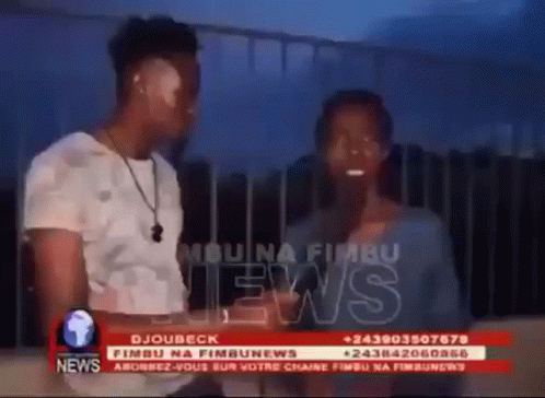 Man and Woman in Front of News Screen