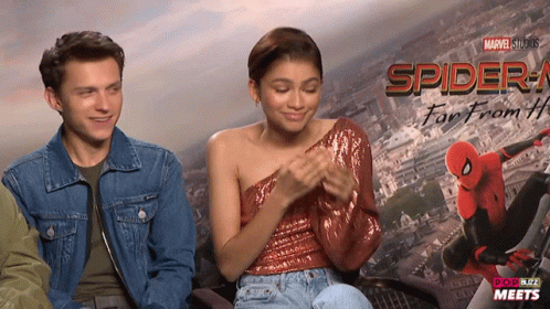 Man And Woman In Front Of Spider-Man Far From Home Poster GIF
