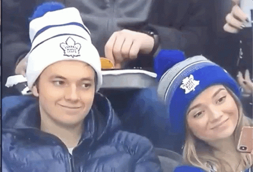 Man and Woman in Maple Leaf Beanies