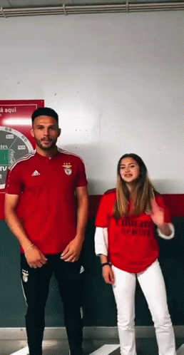 Man and Woman in Red Emirates Shirts