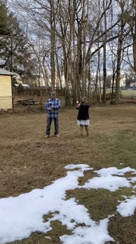 Man and Woman in Snowy Field