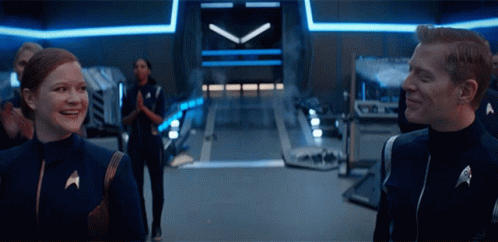 Man and Woman in Star Trek Uniforms Smiling