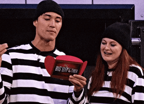 Man and Woman in Striped Shirts Holding Box Saying Big Brother