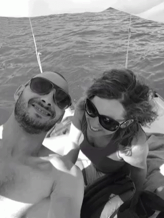 Man and Woman in Sunglasses Posing in Water