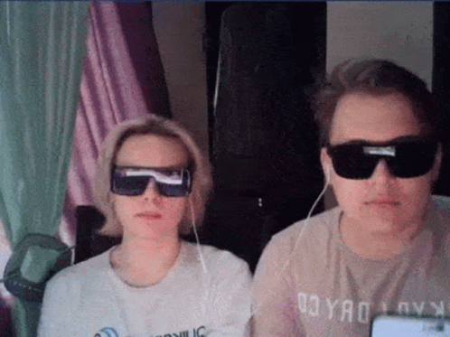Man and Woman in Sunglasses Sitting Together