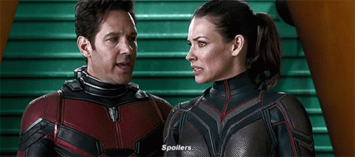 Man and Woman in Superhero Costumes Standing and Talking