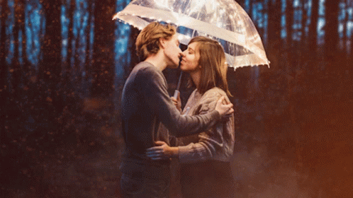Man And Woman Kiss Under Umbrella Lights GIF