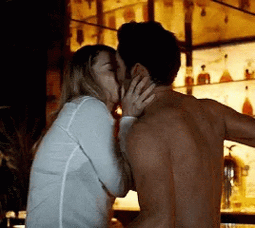 Man and Woman Kissing at Bar