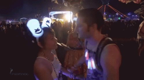 Man and Woman Kissing at Concert