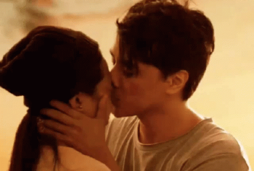 Man And Woman Kissing At Sunset GIF