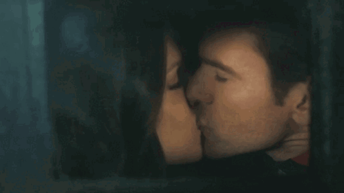 Man And Woman Kissing Behind Window GIF