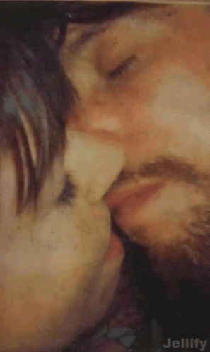 Man and Woman Kissing Cheek