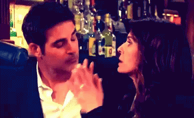Man and Woman Kissing in Bar