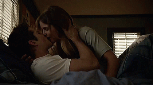 Man and Woman Kissing in Bed
