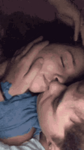 Man and Woman Kissing in Bed