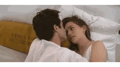 Man and Woman Kissing in Bed
