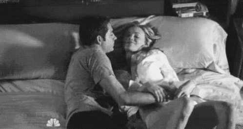 Man And Woman Kissing In Bed GIF
