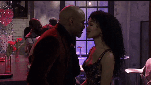 Man and Woman Kissing in Crowd