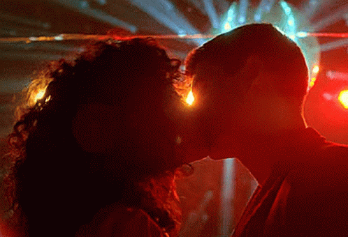 Man and Woman Kissing in Dark Room