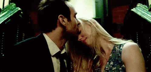 Man and Woman Kissing in Dark Room