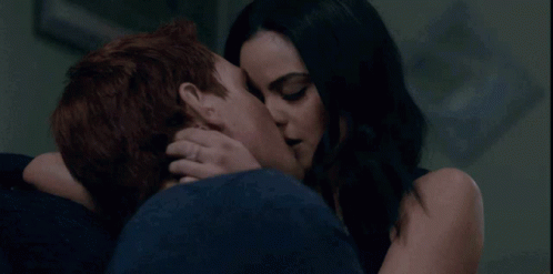 Man and Woman Kissing in Dark Room