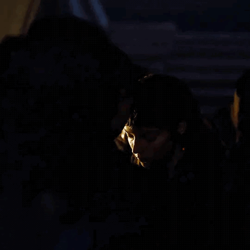 Man and Woman Kissing in Dark Room