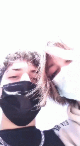 Man and Woman Kissing in Face Masks
