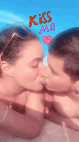 Man and Woman Kissing in Front of Blue Sky and Pink Heart