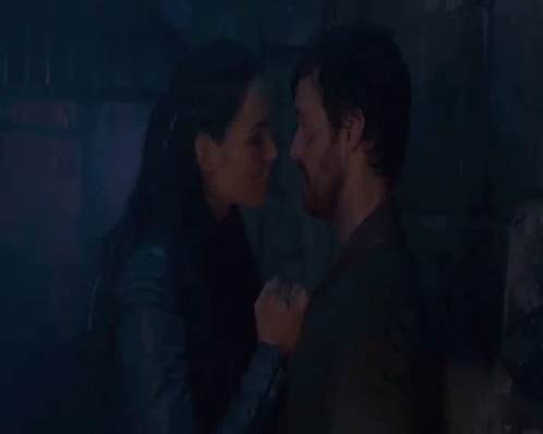 Man And Woman Kissing In Front Of Fire GIF