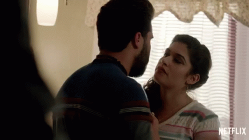 Man and Woman Kissing in Front of Netflix