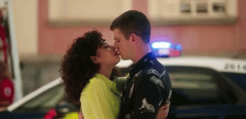 Man And Woman Kissing In Front Of Police Car GIF
