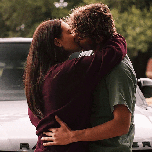 Man And Woman Kissing In Front Of Range Rover GIF