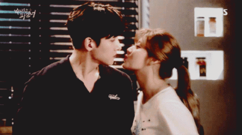 Man And Woman Kissing In Front Of SBS Sign GIF
