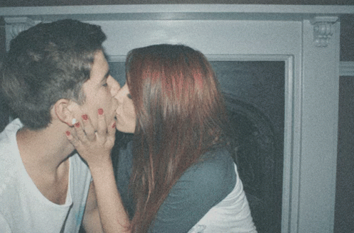 Man And Woman Kissing In Front Of Window GIF